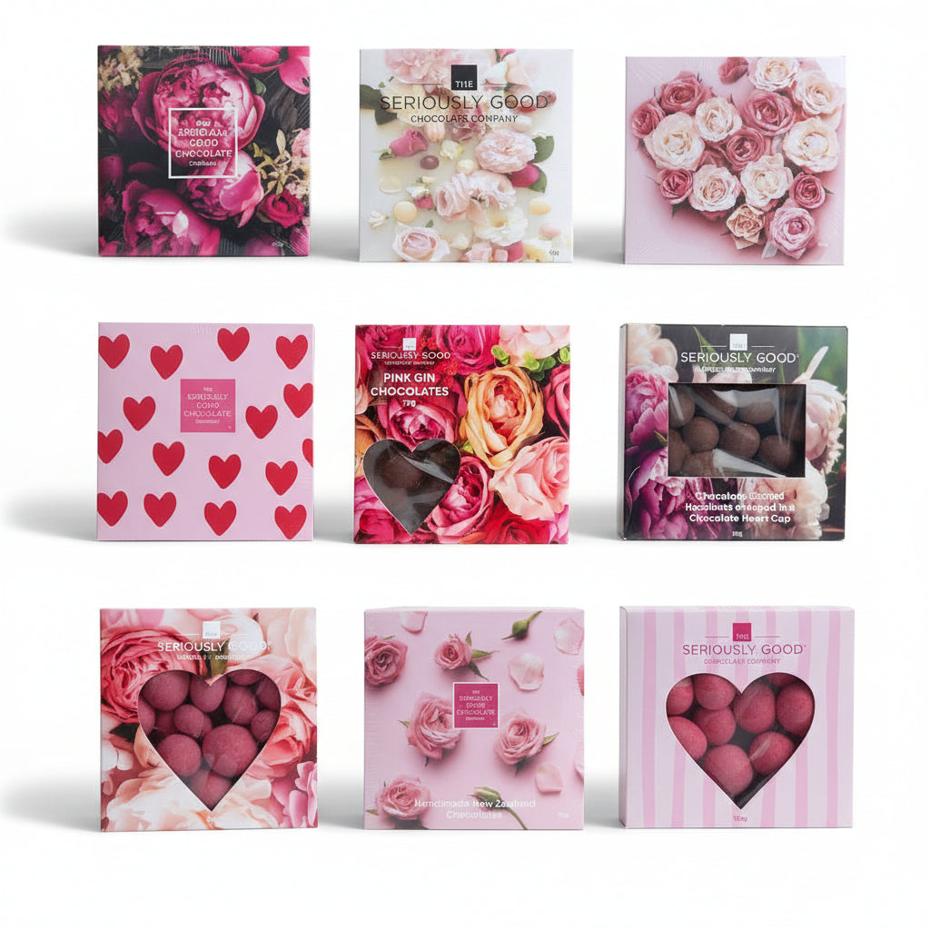 Collection of chocolate boxes with floral and heart designs on a wooden surface