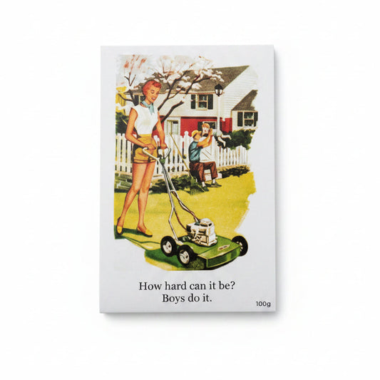 A rectangular printed card or poster with a vintage-style illustration of a woman pushing a lawn mower while a boy mows a lawn in front of a house. Below the illustration, the text reads, 'How hard can it be? Boys do it.