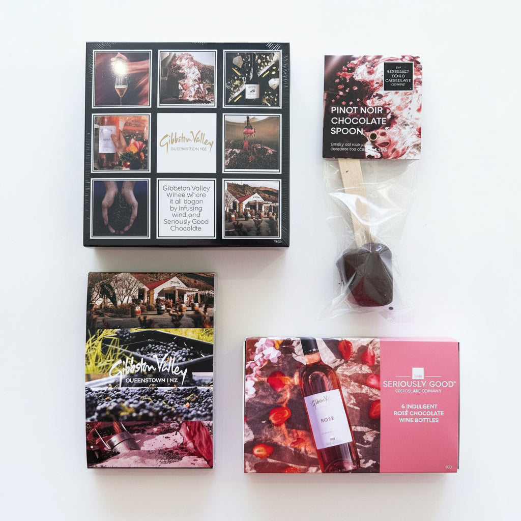 A variety of gift boxes and items, potentially including chocolate and wine, arranged on a table. Boxes may contain chocolate or wine, and there is a chocolate bar visible in a clear packaging.