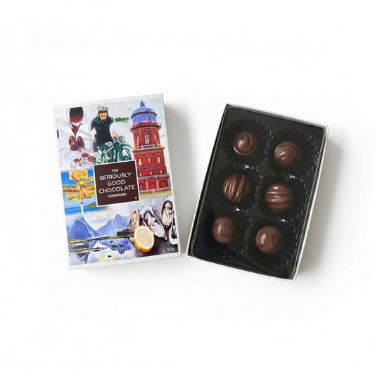 A box of six chocolate candies next to its packaging, which has images and text related to the Southland region, indicating a connection to the Burt Munro race and local landmarks.