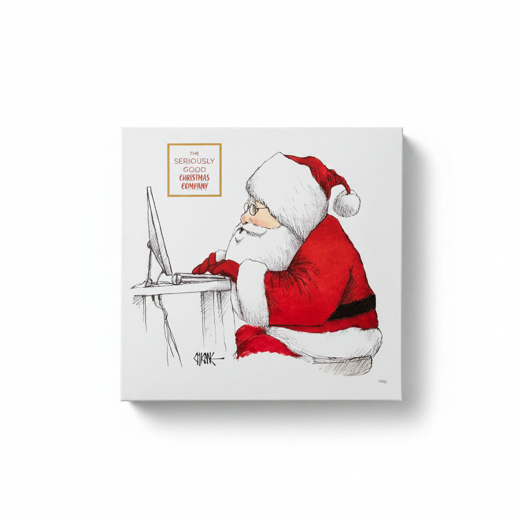 A box of chocolates with a Christmas-themed illustration of Santa Claus sitting at a desk, surrounded by a decorative tree and gifts, with a marshmallow snowman in the foreground.