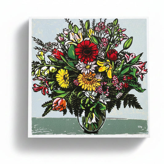 A box of chocolate containing a 16 piece collection with a vibrant, colorful floral design on the lid.