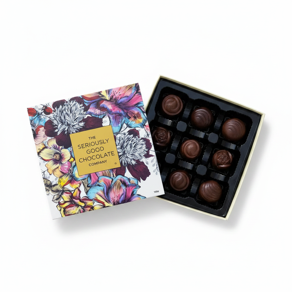 Open Box of The Seriously Good Chocolate Company 9 Piece Indulgent Artisan Chocolates Botanica Collection Handmade in Southland NZ decorated with blue, pink & red flowers plus chocolates